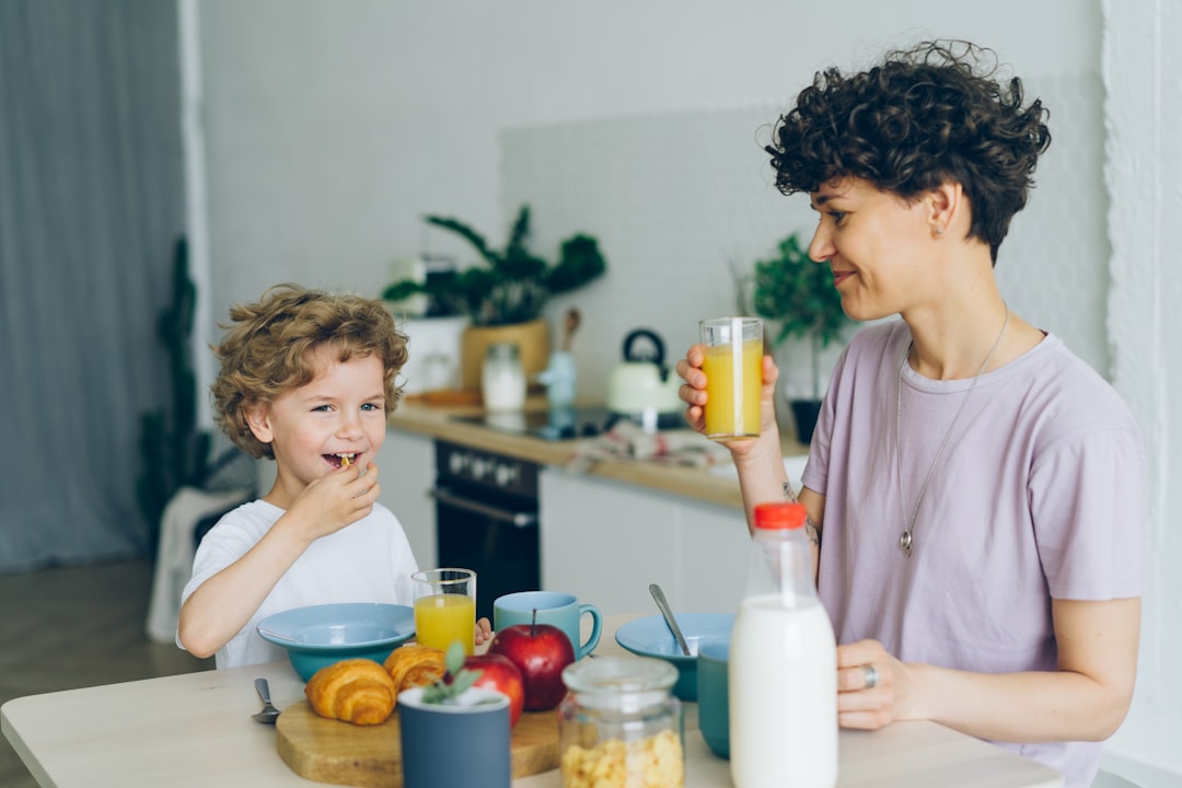 Mother and child at kitchen table, representing everyday family wellness
