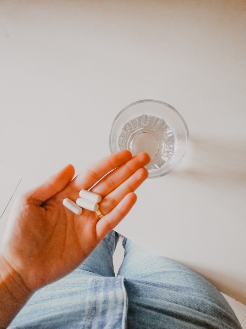 Person holding a vitamin supplement